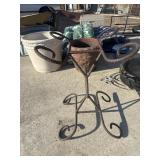 Rustic, rebar-and-wrought-iron plant stand.