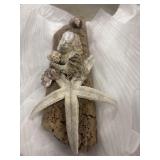 Handcrafted coastal wall art piece features a