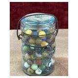 Vintage blue glass canning jar filled with marbles