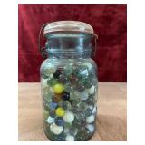 Vintage blue glass canning jar with marbles,