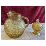 Glass ball pitcher and amber glass candy dish.