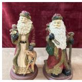 Pair of vintage resin Santa Claus figurines.