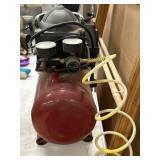 Red tank device shown is a portable 2-gallon "hot