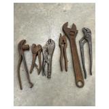 Bundle of assorted pliers, locking grips, and
