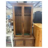 Solid wood display and storage gun cabinet.