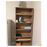 Tall, open-back wooden bookcase with a light oak