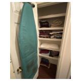 Closet full of throw pillows and thro blankets.