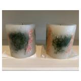 Botanical wax-embedded pillar candles.