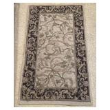 Small Waverly rectangular accent rug featuring a