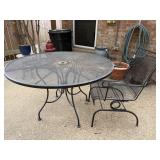 Round black iron outdoor table with one chair