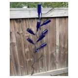 Handcrafted metal wall-hanging bottle tree.