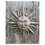 Rustic cast metal sun face wall plaque.