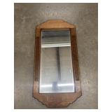 Vintage wooden wall mirror with a carved oak