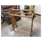 Freestanding wooden quilt rack or blanket holder.