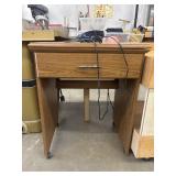 Vintage laminate-wood folding sewing machine