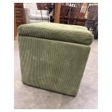 Compact olive green corduroy storage ottoman.