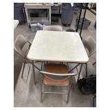 Card table with 4 folding chairs.