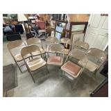 9 brown metal folding chairs.