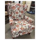 Modern wingback accent armchair. Upholstered in a