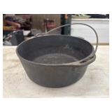 Black cast iron Dutch oven with a wire bail