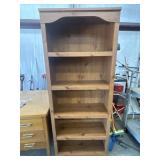 Tall, freestanding wooden bookshelf with five