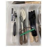 Kitchen utensils like wooden-handled knives, a