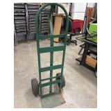 Heavy-duty green steel loop-handle hand truck.