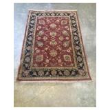Traditional hand-knotted oriental area rug.