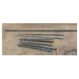 Collection of long steel drill bits, including