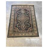 Traditional hand-knotted wool area rug.