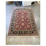Traditional hand-knotted wool area rug.