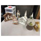 Several Christmas nativity scenes, figurines, and
