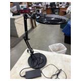 A black LED magnifying desk lamp with an