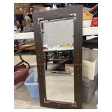 Rustic rectangular wall mirror features a dark
