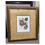 Framed botanical art print featuring green leaves