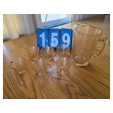 Carnival glass pitcher and cups