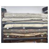 Lot of 17 assorted rugs on rack