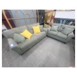 Sofa and love seat with table and windowpane