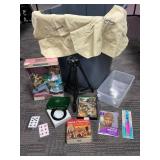 Household Items Including Doll, CDs, and Tripod