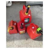 Four Red Plastic Gasoline Cans