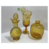 Three Amber Glass Decorative Vessels