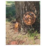 Set a three terra-cotta sun faces with metal...