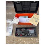 Orange toolbox with gun manuals, and tools