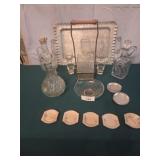 Glass decanters, 5 butter pats, cup coasters