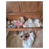 Drawer full of doll heads, legs, body parts, etc
