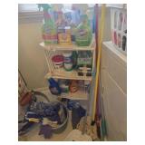 Laundry shelf with cleaning supplies, mop, broom,
