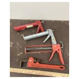 14" pipe wrench and 3 caulking guns