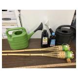 2 bamboo tiki torches with partial bottles of