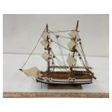 white blue striped ship,one sail needs reattached