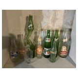 11 bottles, includes Coca-Cola, Sprite, Hires,